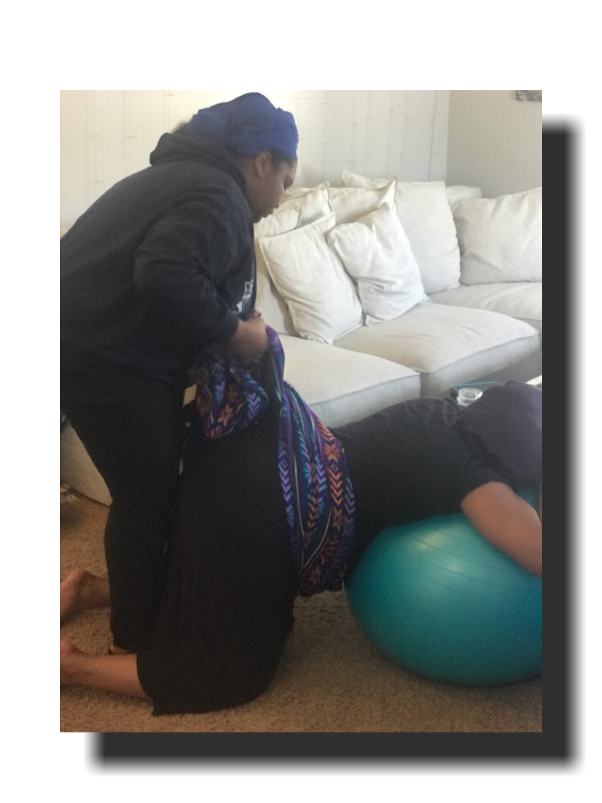 Doula supporting a laboring mother on a birth ball