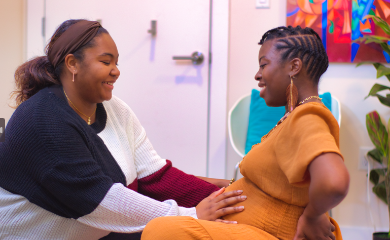 Doula sharing a moment with a pregnant mother